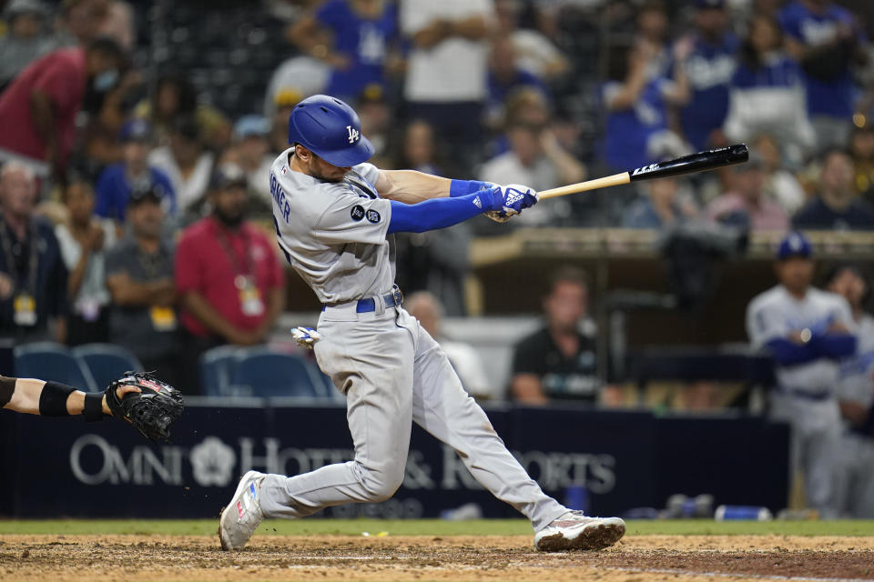 Los Angeles Dodgers' Trea Turner hits an RBI-single during the fifteenth inning of a baseball game against the San Diego Padres, Thursday, Aug. 26, 2021, in San Diego. (AP Photo/Gregory Bull)