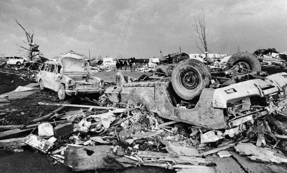 FILE - Cars and debris is strewn over Xenia, Ohio after a tornado ripped through the area on April 4, 1974. The deadly tornado killed 32 people, injured hundreds and leveled half the city of 25,000. Nearby Wilberforce was also hit hard. As the Watergate scandal unfolded in Washington, President Richard Nixon made an unannounced visit to Xenia to tour the damage. Xenia's was the deadliest and most powerful tornado of the 1974 Super Outbreak. (AP Photo)