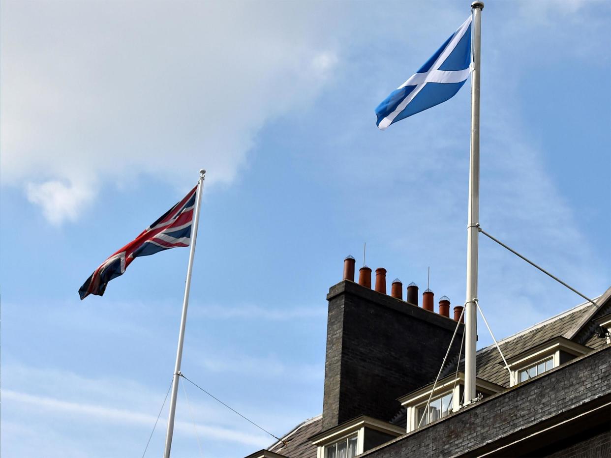 The Scottish flag flutters next to the Union flag over Downing Street in London: Getty