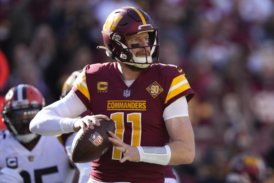 Washington Commanders quarterback Carson Wentz (11) throws a pass during the first half of an NFL football game against the Cleveland Browns, Sunday, Jan. 1, 2023, in Landover, Md. (AP Photo/Susan Walsh)