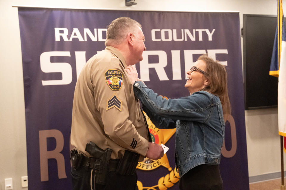 Cpl. Taron Clark has his rank pinned on by his wife for his promotion Thursday at the Randall County Sheriff's Office outside of Amarillo.