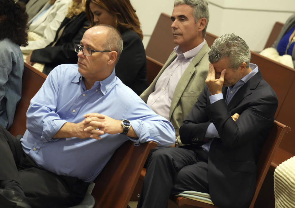 Fred Gutenberg, left, Tom Hoyer, rear center, Max Schachter react to witness testimony during the penalty phase of Marjory Stoneman Douglas High School shooter Nikolas Cruz's trial, Friday, July 22, 2022, at the Broward County Courthouse in Fort Lauderdale, Fla. Cruz previously plead guilty to all 17 counts of premeditated murder and 17 counts of attempted murder in the 2018 shootings. (Mike Stocker/South Florida Sun-Sentinel via AP, Pool)