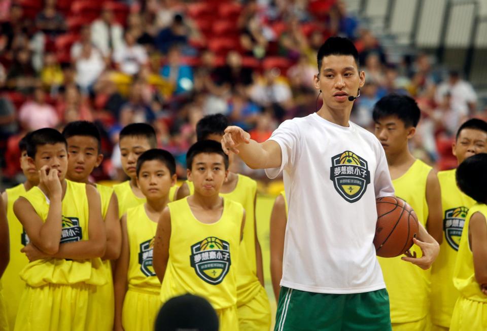 Jeremy Lin talks to young Taiwanese players during a basketball clinic in Taipei, Taiwan in 2019.