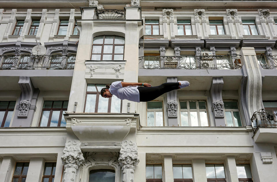 A gymnast performs on a street during the celebrations for the City Day in Moscow