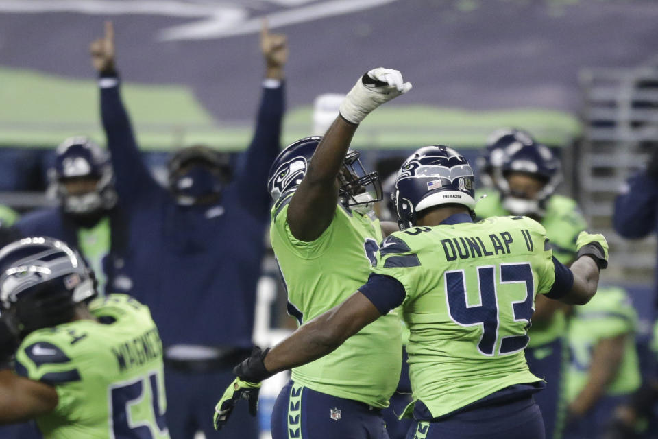 Seattle Seahawks defensive end Carlos Dunlap (43) celebrates with defensive end L.J. Collier, center-left, after Dunlap sacked Arizona Cardinals quarterback Kyler Murray late in the second half of an NFL football game, Thursday, Nov. 19, 2020, in Seattle. The Seahawks won 28-21. (AP Photo/Lindsey Wasson)