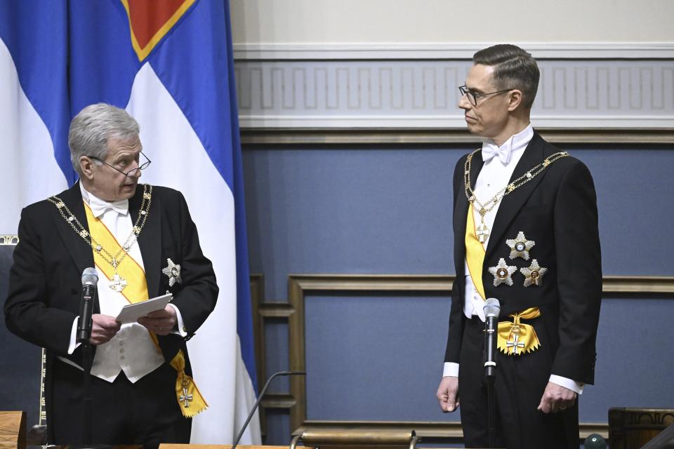 President-elect Alexander Stubb, right, watch as Incumbent President of the Republic of Finland Sauli Niinisto holds his speech at Parliament's plenary session during the inauguration of the President of the Republic of Finland in Helsinki, Finland, Friday March 1, 2024. (Markku Ulander/Lehtikuva via AP)