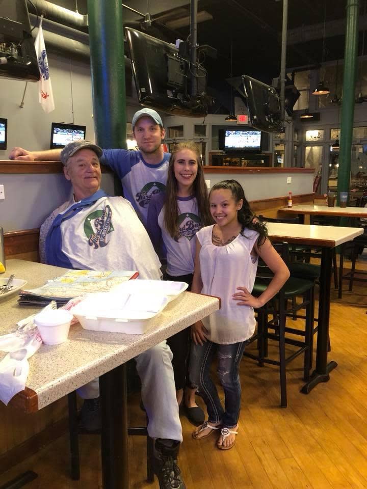 Bill Murray poses for a photo with the staff of Third Base Restaurant and Bar in April 2018.