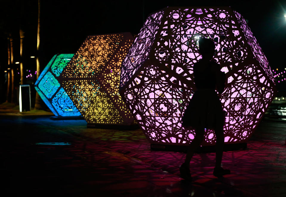 <p>A young girl is silhouetted against an illuminated sculpture titled ‘HYBYCOZO’ during a media preview of the i Light Marina Bay Festival in Singapore on March 1, 2017. The i Light Marina Bay Festival will take place from 03 to 26 March 2017, and features sustainable light art installations by local and international designers. (Wallace Woon/EPA) </p>