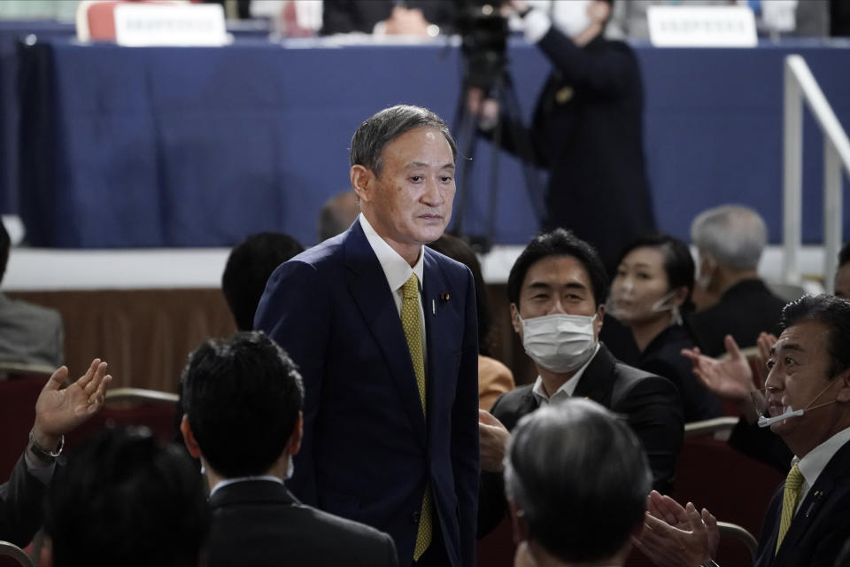 Japanese Chief Cabinet Secretary Yoshihide Suga acknowledges as he is elected as new head of Japan's ruling party at the Liberal Democratic Party's (LDP) leadership election Monday, Sept. 14, 2020, in Tokyo. The ruling LDP chooses its new leader in an internal vote to pick a successor to Prime Minister Shinzo Abe, who announced his intention to resign last month due to illness. (AP Photo/Eugene Hoshiko, Pool)