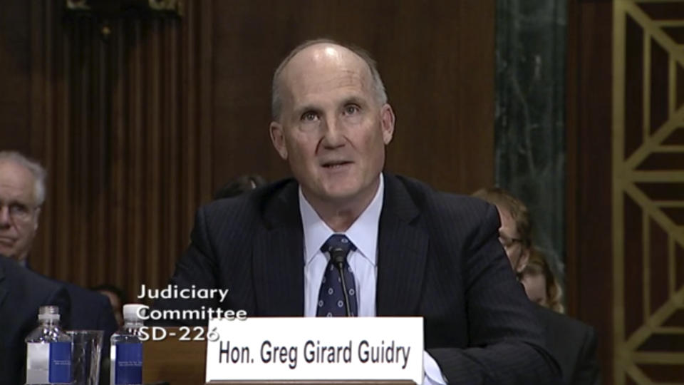 In this image from video provided by the U.S. Senate, Judge Greg Guidry speaks during a hearing for district court nominees held by the Senate Committee on the Judiciary in Washington, on Wednesday, Feb. 13, 2019. Guidry donated tens of thousands of dollars to New Orleans’ Roman Catholic archdiocese and consistently ruled in favor of the church amid a contentious bankruptcy involving nearly 500 clergy sex abuse victims, The Associated Press found, an apparent conflict that could throw the case into disarray. (U.S. Senate via AP)