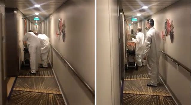 Industrial suit-clad crew members spraying the boat's hallways. Source: Ash on the Ovation/Facebook