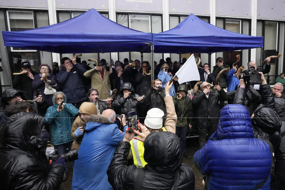 Photographers watch Jewish people and sympathisers blow shofars (ram's horns of spiritual significance) and whistles in London, Sunday, March 10, 2024 to show solidarity with the 100 plus hostages held in Gaza. The 'blow' lasted for 1.55 minutes marking the 155 days they have spent in captivity. (AP Photo/Frank Augstein)