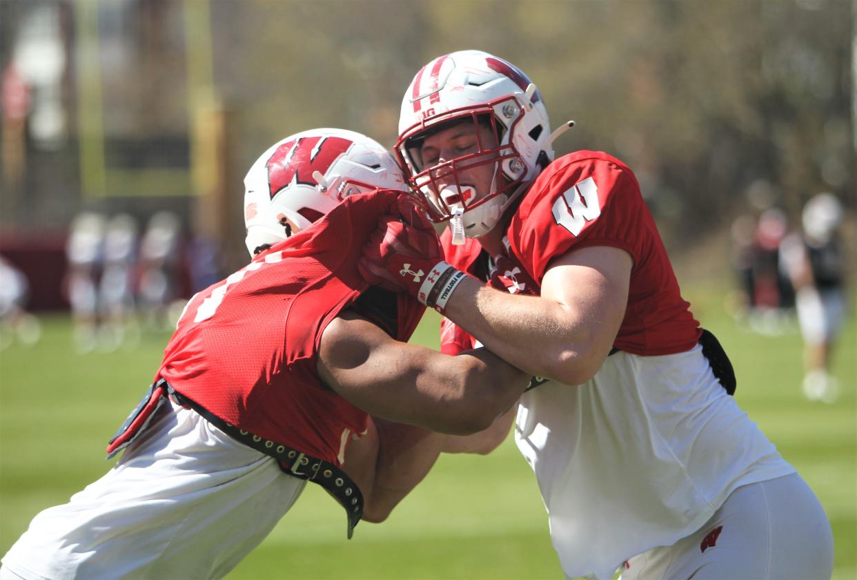 Wisconsin tight end Riley Nowakowski, left, takes on Grant Stec  during spring spring practice.