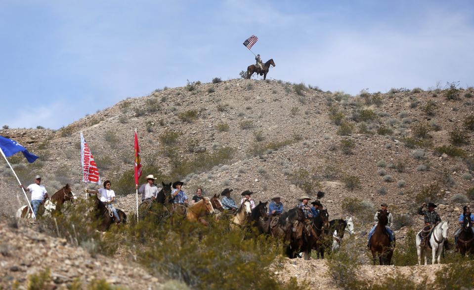 Protesters on horseback ride on the hills above a rally site in Bunkerville, Nevada, April 12, 2014. Clark County Sheriff Douglas Gillespie announced the Bureau of Land Management (BLM) was ceasing its cattle roundup operation. Armed U.S. rangers had been rounding up cattle on federal land in Nevada in a rare showdown with Cliven Bundy, a rancher who has illegally grazed his herd on public lands for decades, as conflict over land use simmers in western states. The standoff with the BLM stems in part from Bundy's belief that their right to graze the land predates the federal government's management of it, and that the county and state should ultimately have authority over lands in their boundaries. REUTERS/Jim Urquhart (UNITED STATES - Tags: CIVIL UNREST AGRICULTURE ANIMALS ENVIRONMENT CRIME LAW TPX IMAGES OF THE DAY)