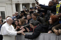 Pope Francis salutes faithful in St. Peter's Square at the Vatican before leaving after his weekly general audience, Wednesday, Feb. 26, 2020. (AP Photo/Alessandra Tarantino)