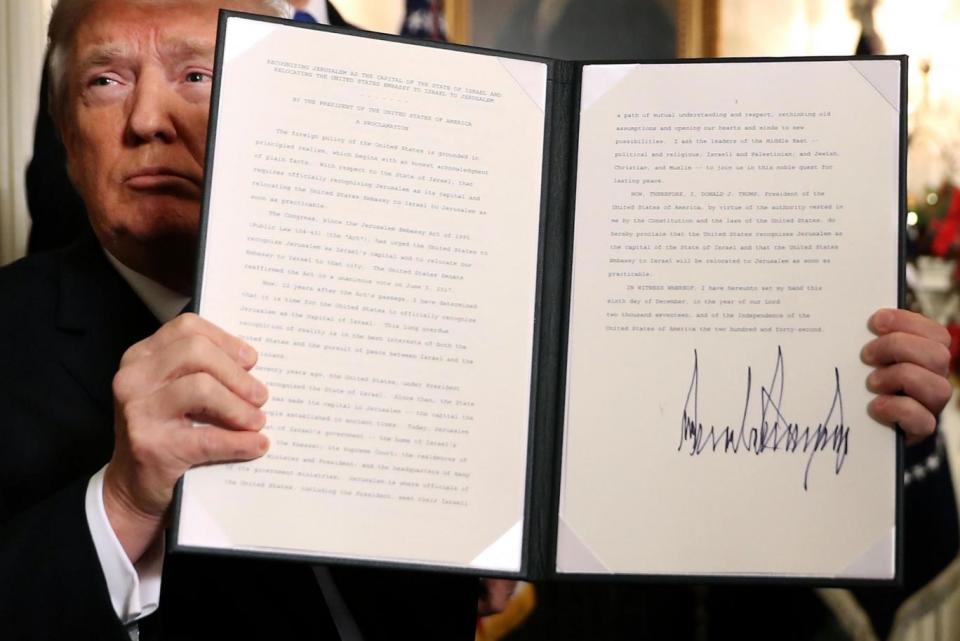 Mr Trump holds up a proclamation that the US government will formally recognize Jerusalem as the capital of Israel. (Getty Images)