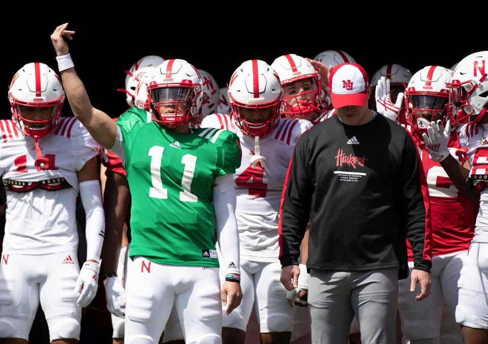 Nebraska red team quarterback Casey Thompson (11) signals the crowd before leading the both the red and white teams onto the field alongside head coach Scott Frost before Nebraska's NCAA college football annual red-white spring game at Memorial Stadium in Lincoln, Neb., Saturday, April 9, 2022. (AP Photo/Rebecca S. Gratz)