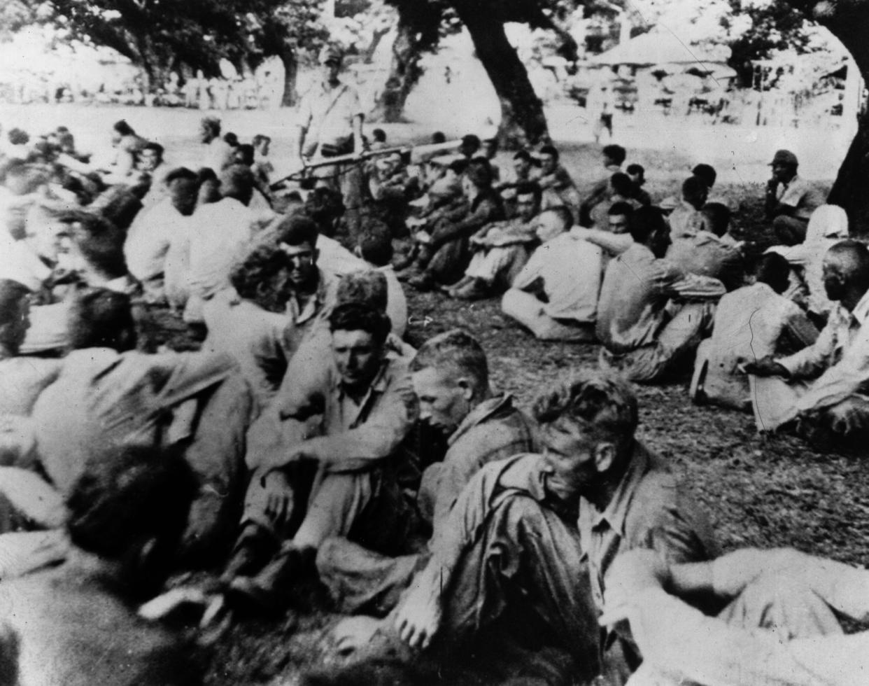 American prisoners of war held by the Japanese at Bataan in 1944. Here they are herded together prior to continuing the march of death, during which 67,000 prisoners died. These prisoners were interned at Camp O'Donnell, from which some were later released by Gen. Douglas MacArthur's forces.