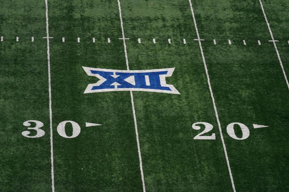 The Big 12 Conference logo is seen on the field at Memorial Stadium during the second half of an NCAA college football game between Kansas and Oklahoma State Saturday, Nov. 5, 2022, in Lawrence, Kan. (AP Photo/Charlie Riedel)