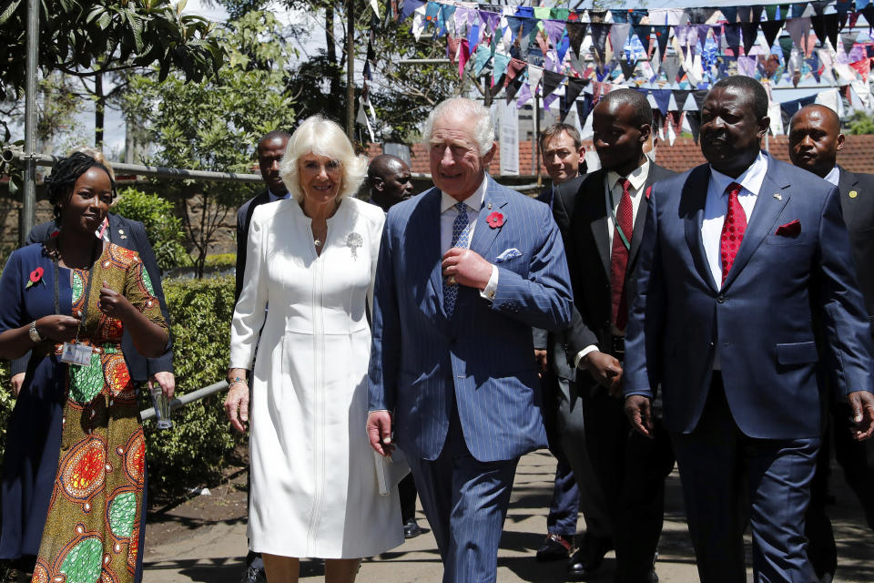 Britain's King Charles III, center, and Queen Camilla, center left, arrive to visit the Eastlands Library to learn about a project that restores old libraries and encourages reading amongst children in the community in Makadara district of Nairobi, Tuesday, Oct. 31, 2023. King Charles is in Kenya for a four-day trip, his first state visit to a Commonwealth country as monarch, underscoring his commitment to an organization that's been central to Britain’s global power and prestige since World War II. (Thomas Mukoya/Pool Photo via AP)