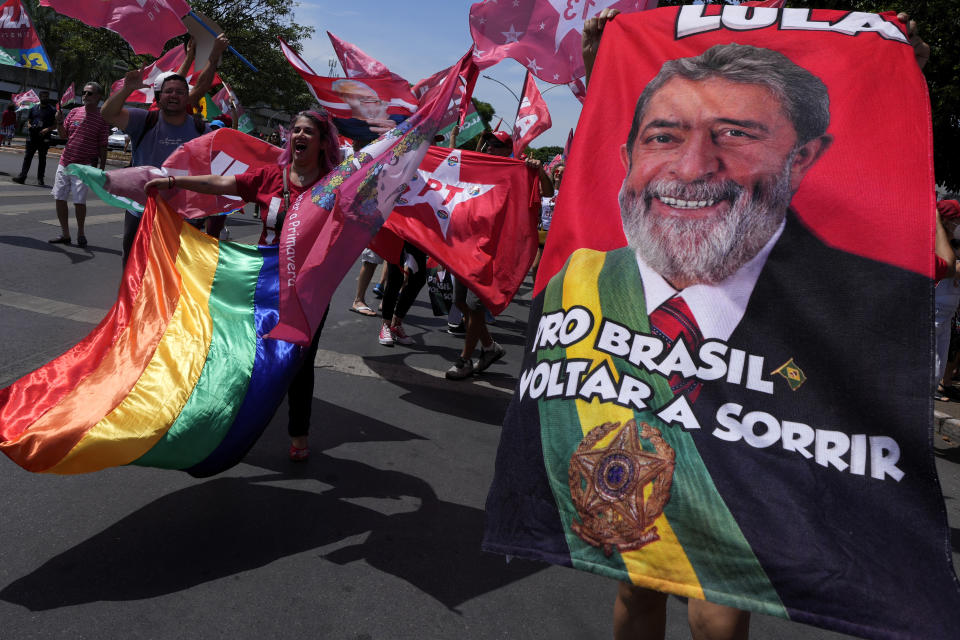 A supporter holds a towel emblazoned with an image of Brazil's former President Luiz Inacio Lula da Silva during a campaign event in Brasilia, Brazil, Saturday, Oct. 29, 2022. Da Silva is facing incumbent Jair Bolsonaro in a runoff election set for Oct. 30. (AP Photo/Eraldo Peres)