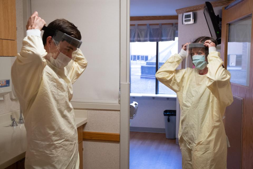 Stephanie Childs, right, environmental services day shift supervisor, instructs Jeffrey Kaethner, an environmental services tech, on proper use of PPE before entering rooms at UW Hospital in Madison on May 6.