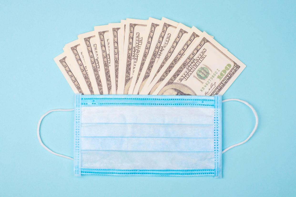 An image of a face mask with money in it.