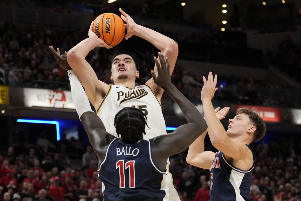 FILE - Purdue center Zach Edey (15) shoots over Arizona center Oumar Ballo (11) in the second half of an NCAA college basketball game in Indianapolis, Saturday, Dec. 16, 2023. Edey was the unanimous choice as AP All-Big Ten player of the year in voting released Tuesday, March 12, 2024. (AP Photo/AJ Mast, File)