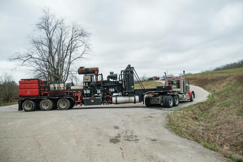 Fracking equipment makes its way from Timmerman Road to the scene of an oil wellhead fire at the CHK Jamar Pad owned and maintained by Encino Energy in North Township in Harrison County.