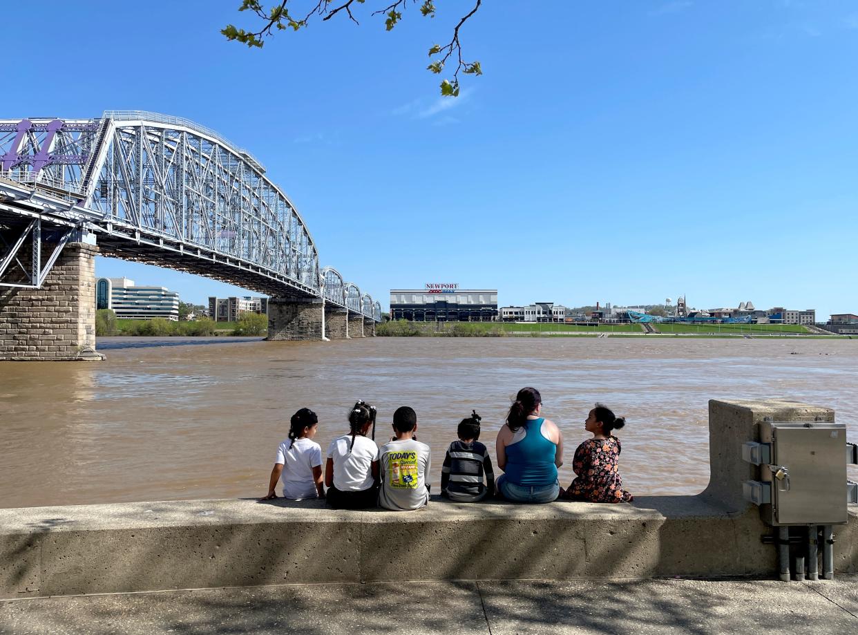 A family sits at the Serpentine Wall at Sawyer Point in downtown Cincinnati as the Sunday, April 14, 2024.
A flood advisory emains in effect until early Thursday morning for the Ohio River