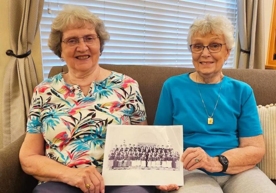 PHOTO: Sylvia Crane, left, and Joan Harris hold a class photo from Mt. St. Mary’s Academy in Grass Valley, California. (Courtesy Atria Senior Living)