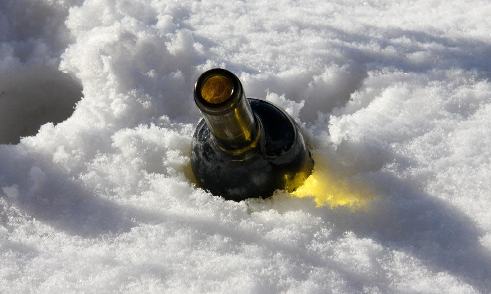 Bottle of wine chilling in snow