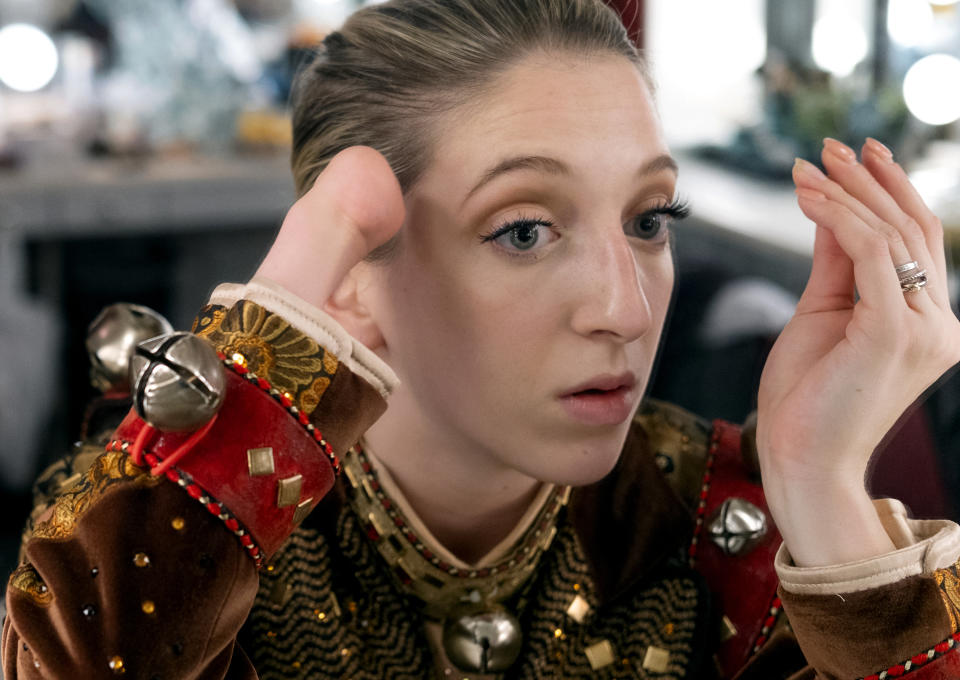 In this Monday, Dec. 2, 2019 photo, Rockette Sydney Mesher checks and eye lash extension she has just put on in her dressing room at Radio City Music Hall in New York. Mesher, who was born without a left hand due to the rare congenital condition symbrachydactyly, is the first person with a visible disability ever hired by New York's famed Radio City Rockettes. (AP Photo/Craig Ruttle)
