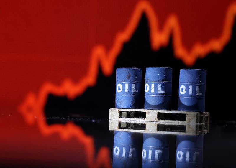 Illustration shows Oil barrels in front of rising stock graph