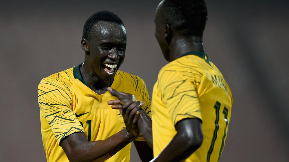 Awer Mabil (R) celebrates with Thomas Deng (L) scoring his side’s fourth goal. (Photo by Tom Dulat/Getty Images)