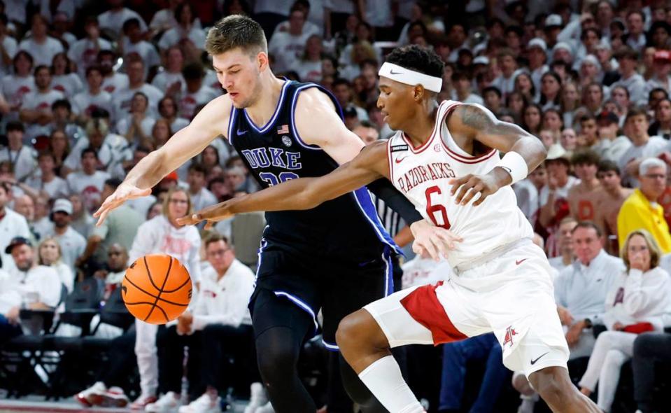 Duke’s Kyle Filipowski (30) and Arkansas’ Layden Blocker (6) go after the ball during the second half of Arkansas’ 80-75 victory over Duke at Bud Walton Arena in Fayetteville, Ark., Weds. Nov. 29, 2023.