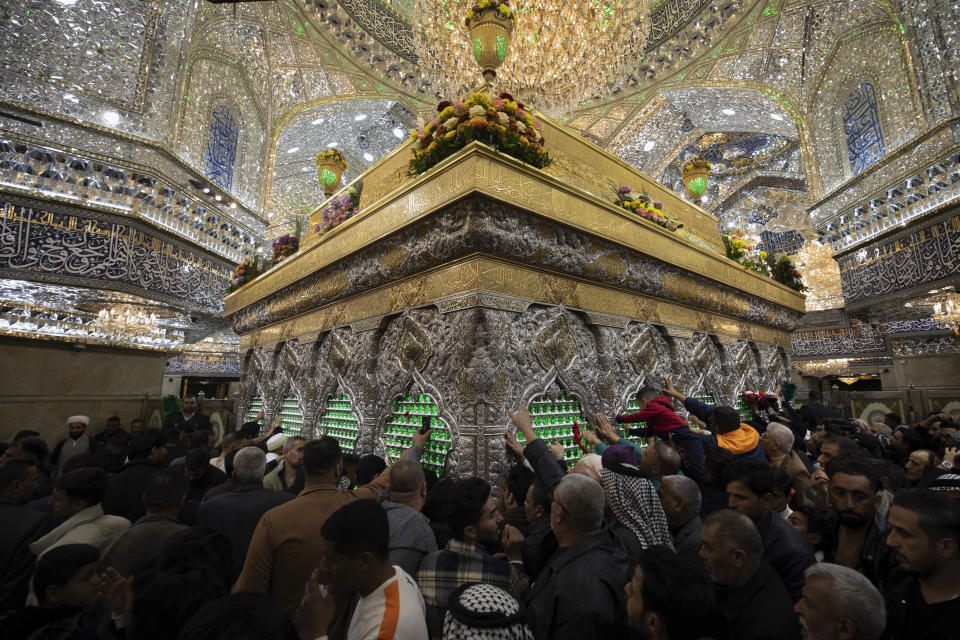 Shiite Muslim pilgrims visit the holy shrine of Imam Hussein in Karbala, Iraq, Friday, Jan. 12, 2024. (AP Photo/Hadi Mizban)