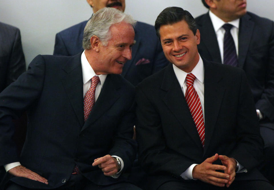 Enrique Pena Nieto, presidential candidate for the Institutional Revolutionary Party, PRI, right, listens to Mexican businessman Alejandro Marti, left, during an event hosted by the non-governmental organization Mexico SOS, that advocates security and justice, in Mexico City, Monday April 2, 2012. The four candidates for Mexico's presidency officially launched their campaigns for the July 1 election on Friday, all of them promising change. (AP Photo/Alexandre Meneghini)