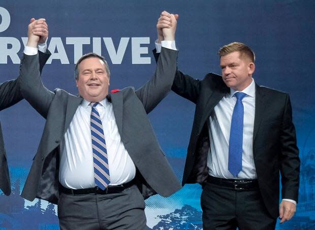 Jason Kenney celebrates his 2017 victory as the first official leader of the Alberta United Conservative Party with his opponent, Brian Jean, at right.