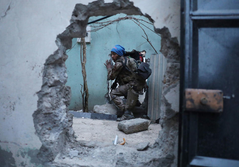 <p>An Iraqi Special Forces soldier moves through a hole as he searches for Islamic State fighters in Mosul, Iraq February 27, 2017 (Goran Tomasevic/Reuters) </p>