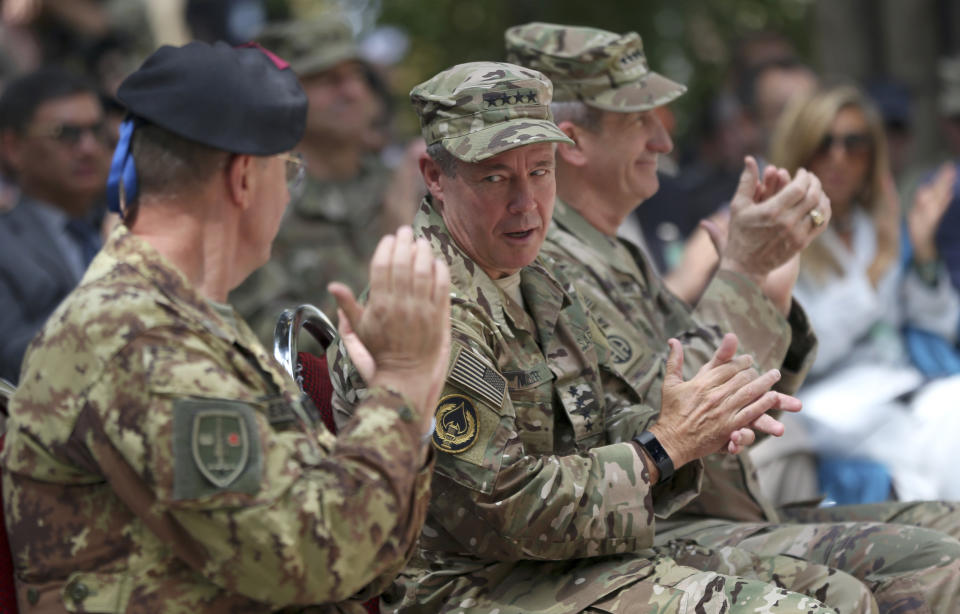 Incoming U.S. Army Gen. Austin Miller, second from left, talks to his colleague as outgoing U.S. Army Gen. John Nicholson, third from left, claps during the change of command ceremony at Resolute Support headquarters, in Kabul, Afghanistan, Sunday, Sept. 2, 2018. Miller has assumed command of the 41-nation NATO mission in Afghanistan following a handover ceremony. (AP Photo/Massoud Hossaini)