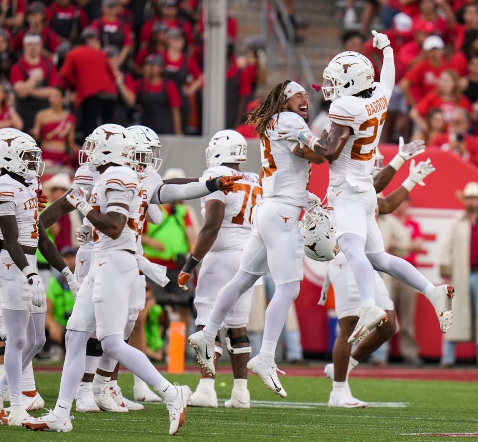 Texas wide receiver Jordan Whittington and defensive back Jahdae Barron, right, celebrate a 31-24 win over Houston on Oct. 21. Barron's fourth-down pass breakup in the closing minutes sealed the win and helped keep UT in the College Football Playoff chase.