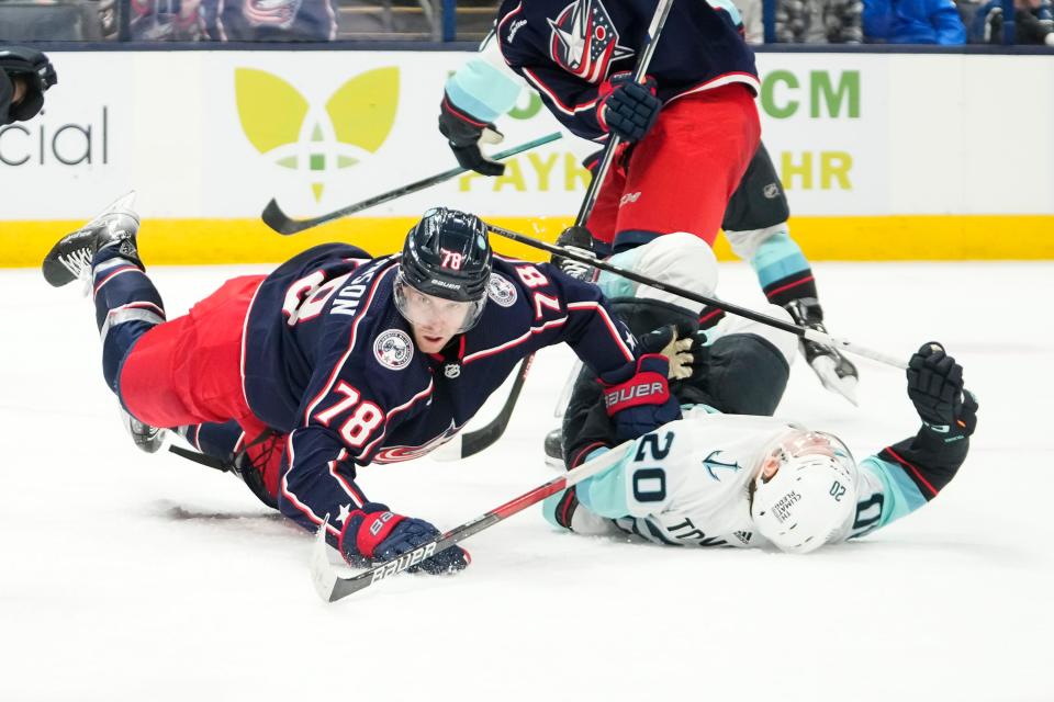 Jan 13, 2024; Columbus, Ohio, USA; Columbus Blue Jackets defenseman Damon Severson (78) hits Seattle Kraken right wing Eeli Tolvanen (20) during the second period of the NHL hockey game at Nationwide Arena.