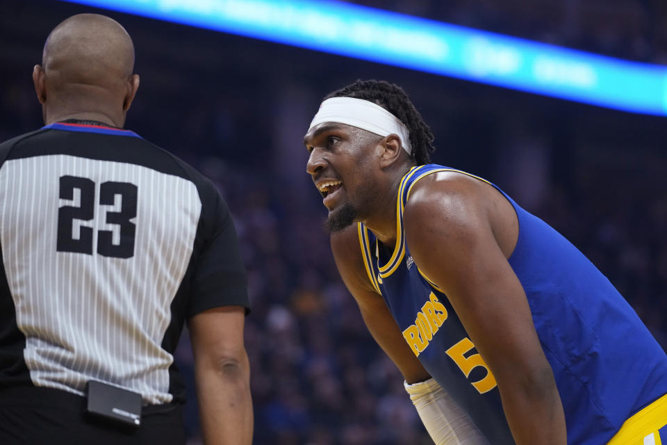 Golden State Warriors forward Kevon Looney talks to referee Tre Maddox during the first half of the team's NBA basketball game against the Charlotte Hornets in San Francisco, Tuesday, Dec. 27, 2022. (AP Photo/Godofredo A. Vásquez)