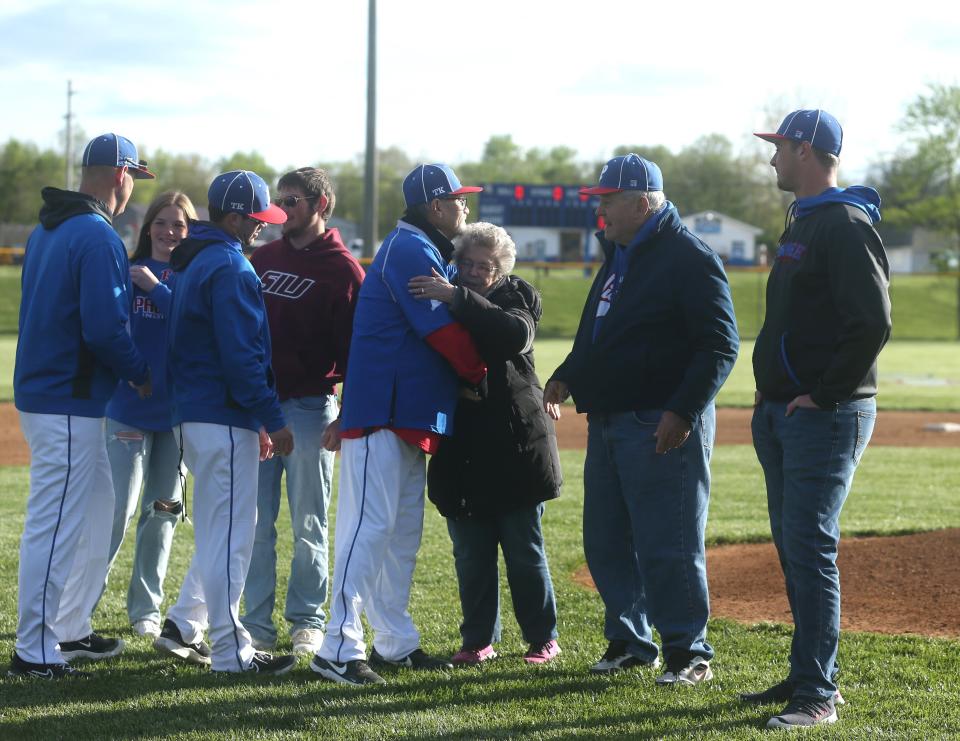 The Pawnee baseball team embraces the Kratochvil family during a pregame ceremony on Saturday, April 20, 2024. From left to right, that included Tim Kratochvil's daughter, Olivia; son, Luke; mom, Mary; dad, Roger; and son, Luke.