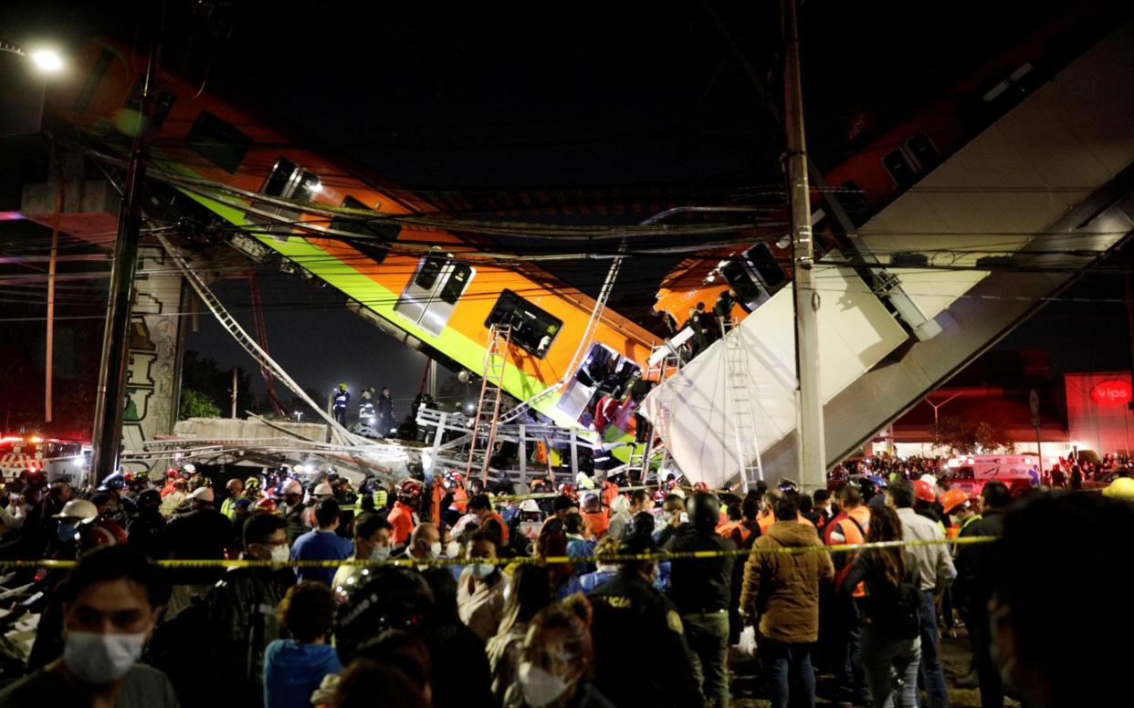 Rescuers work at a site where an overpass for a metro partially collapsed with train cars on it at Olivos station in Mexico City - REUTERS/Luis Cortes