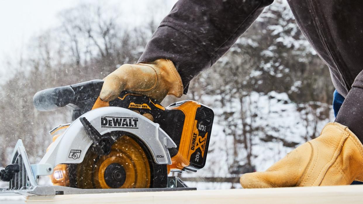 a person using a power saw in the cold