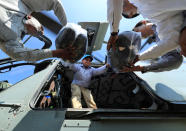 <p>Sanjay Kumar, district magistrate of Allahabad, helps unload relief materials from an Indian Air Force helicopter, in Allahabad, India, Wednesday, Aug. 24, 2016. (AP Photo/Rajesh Kumar Singh)</p>