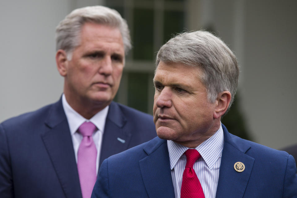 House Minority Leader Kevin McCarthy of Calif., left, stands as Rep. Michael McCaul, R-Texas, speaks with reporters after a meeting with President Donald Trump at the White House, Wednesday, Oct. 16, 2019, in Washington. (AP Photo/Alex Brandon)