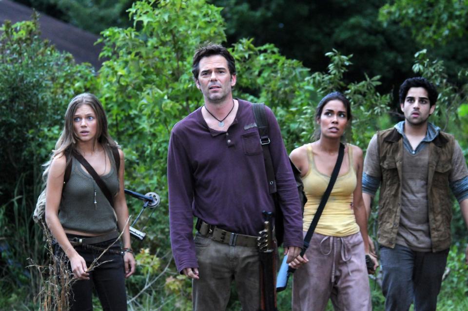 FILE - This undated publicity image released by NBC shows, from left, Tracy Spiridakos as Charlie Matheson, Billy Burke as Miles Matheson, Daniella Alonso as Nora, and Paras Patel as Albert, in a scene from "Revolution." The series by J.J. Abrams tells of a world 15 years after the world inexplicably suffers a power outage. On Monday, Nov. 19, Led Zeppelin's "Kashmir" and "Since I've Been Loving You" will be featured in next week's episode, the same day, Led Zeppelin's "Celebration Day" album and a companion documentary on DVD will be released. (AP Photo/NBC, Brownie Harris, File)